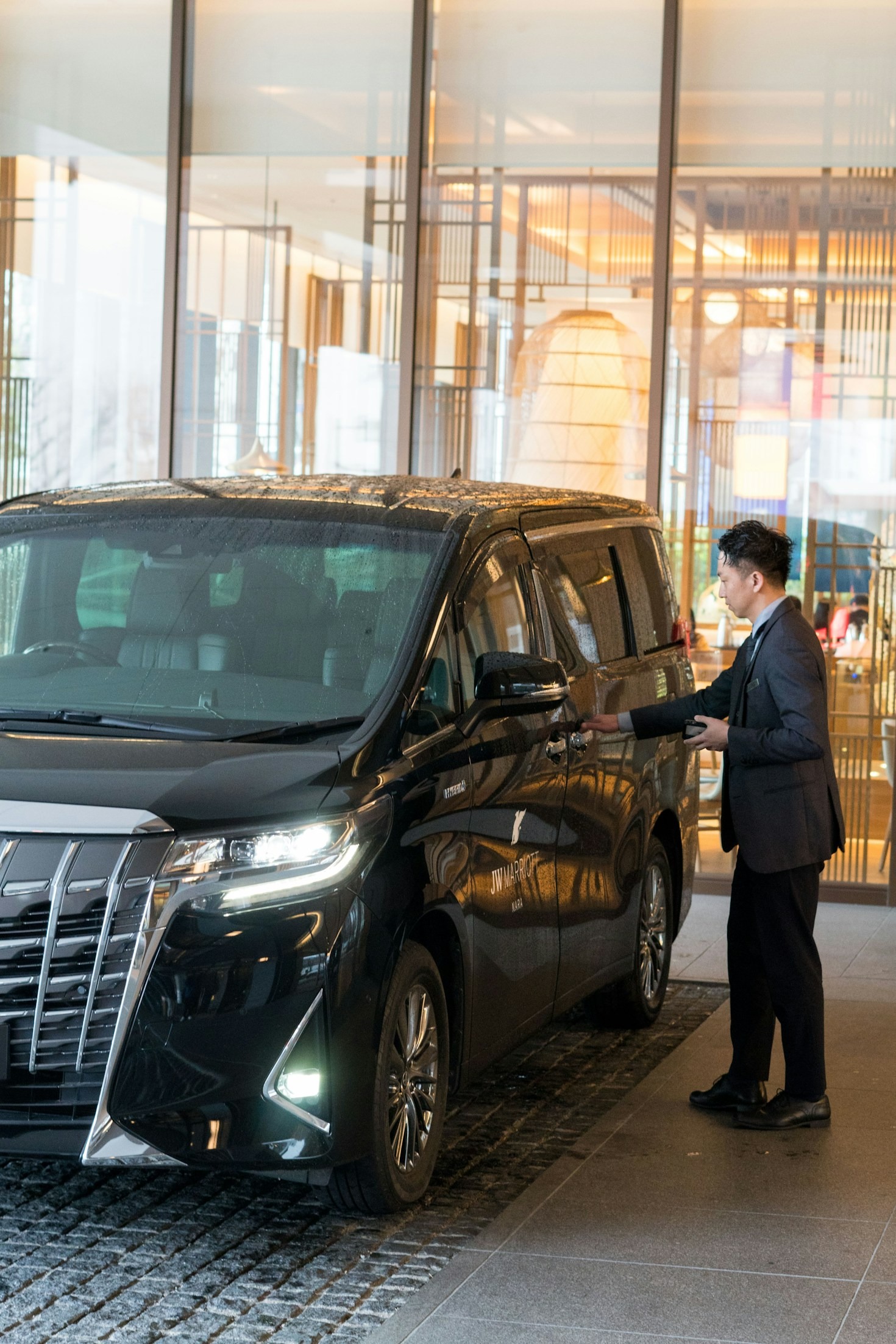 Noir Miami Limo chauffeur loading luggage curbside for a cruise transfer